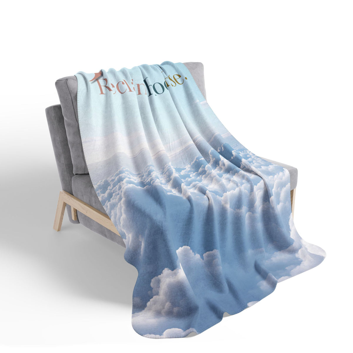Nurse Sherpa Blanket — blue sky and white cloud print draped over a gray armchair