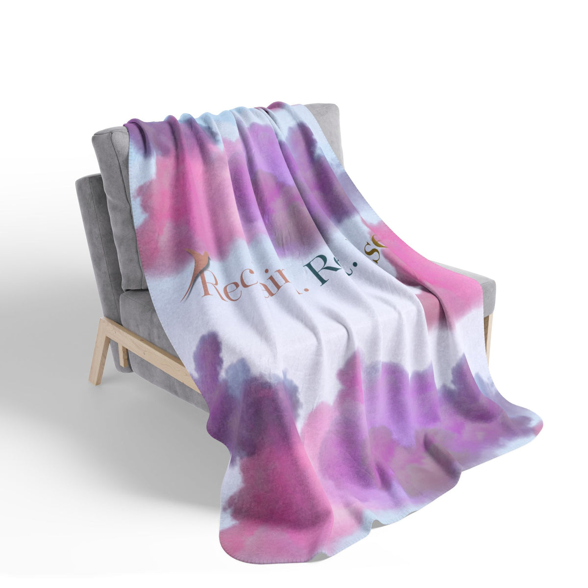 Nurse Sherpa Blanket — pink and purple cloud print draped over a gray armchair