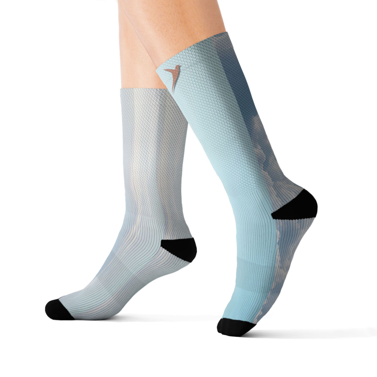 Nurse Crew Socks in light blue and white — blue sky cloud print with black toe and heel, small terracotta bird at the cuff — worn front view